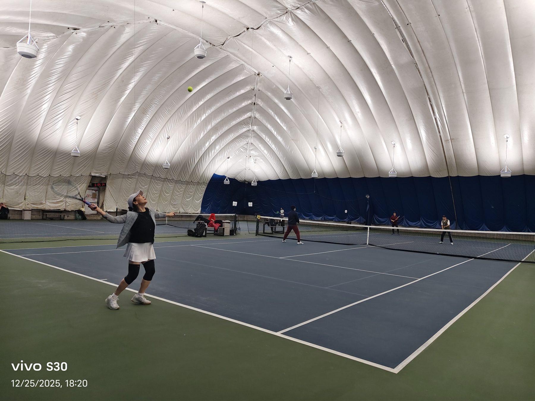 Player serving during the Christmas invitational