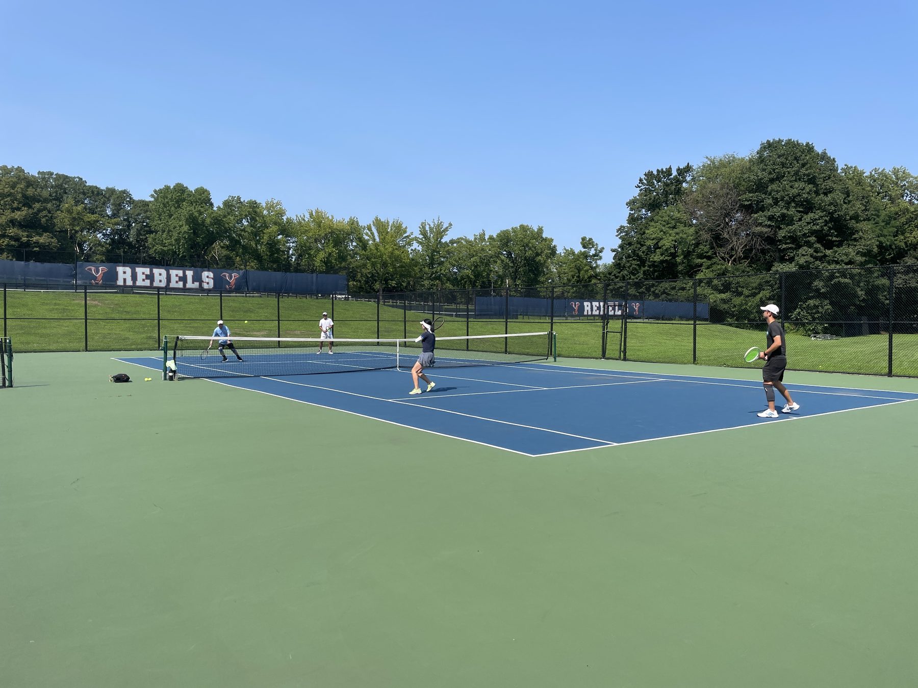 Outdoor doubles match in progress